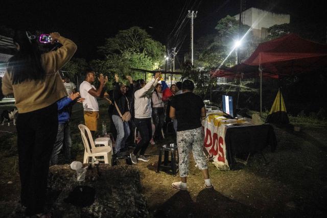 Relatives of political prisoners celebrate the Venezuelan national baseball team's victory in the final of the 2026 World Baseball Classic against the United States team, in front of Rodeo I prison in Guatire, Venezuela on March 17, 2026. Venezuela, where baseball is the national sport, capped off its dream tournament by defeating the favorite, the United States, on home soil, amid tense relations between the two governments following the capture of President Nicolás Maduro by U.S. forces in January. (Photo by Maryorin Mendez / AFP)