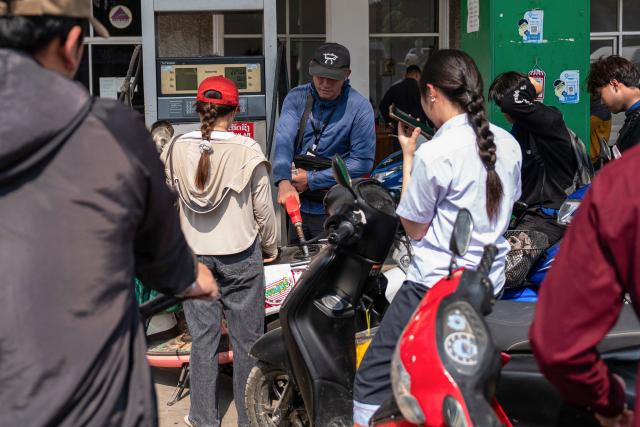 Motorists queue up at a Star Oil petrol station in Luang Prabang on March 16, 2026, following import disruptions caused by the Middle East war. (Photo by AFP)