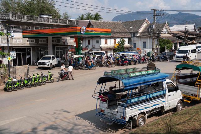 Motorists queue up at a Star Oil petrol station in Luang Prabang on March 16, 2026, following import disruptions caused by the Middle East war. (Photo by AFP)