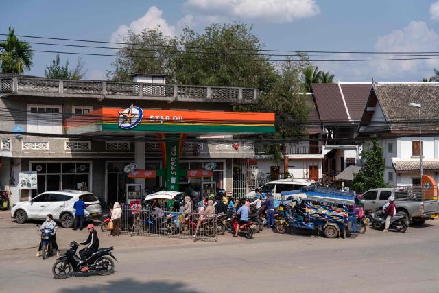 Motorists queue up at a Star Oil petrol station in Luang Prabang on March 16, 2026, following import disruptions caused by the Middle East war. (Photo by AFP)