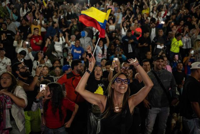 Venezuela fans celebrate their national baseball team's victory in the final of the 2026 World Baseball Classic against the United States team, in Caracas on March 17, 2026. Venezuela, where baseball is the national sport, capped off its dream tournament by defeating the favorite, the United States, on home soil, amid tense relations between the two governments following the capture of President Nicolas Maduro by US forces in January. (Photo by Juan BARRETO / AFP)
