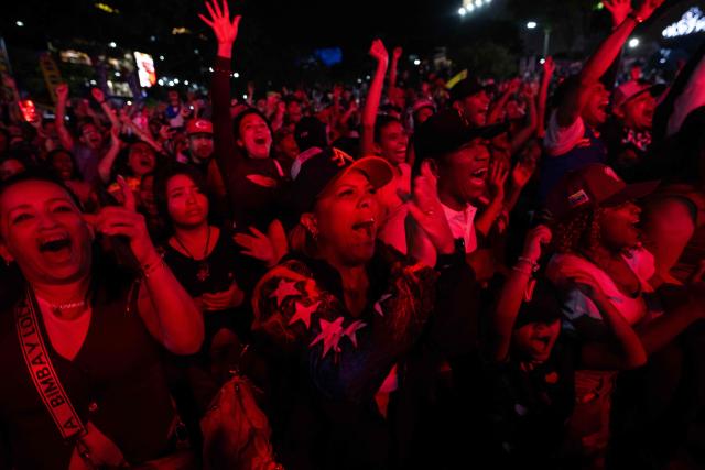 Venezuela fans celebrate their national baseball team's victory in the final of the 2026 World Baseball Classic against the United States team, in Caracas on March 17, 2026. Venezuela, where baseball is the national sport, capped off its dream tournament by defeating the favorite, the United States, on home soil, amid tense relations between the two governments following the capture of President Nicolas Maduro by US forces in January. (Photo by Juan BARRETO / AFP)