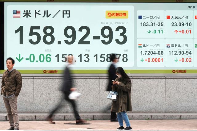 An electronic quotation board displaying the foreign exchange rate of the Japanese yen against the US dollar along a street in Tokyo on March 18, 2026. (Photo by Kazuhiro NOGI / AFP)