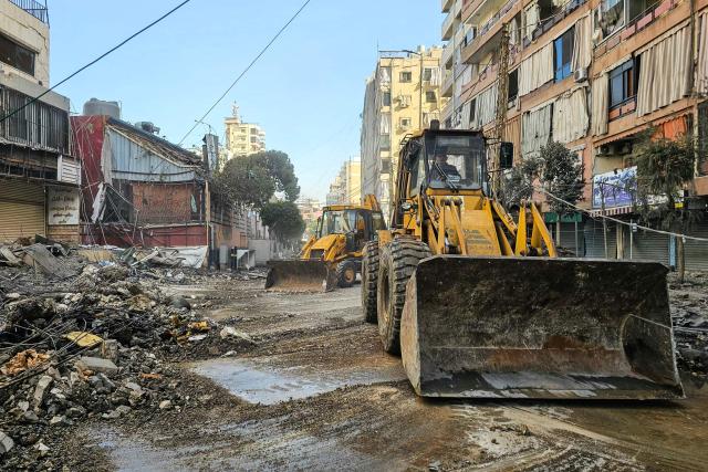 Bulldozers clear debris from a street following an overnight Israeli airstrike in the Bir al-Abed neighbourhood of Beirut’s southern suburbs on March 18, 2026. Lebanon was drawn into the Middle East war on March 2 when Iran-backed militant group Hezbollah launched rockets towards Israel in response to US-Israeli strikes that killed Iranian supreme leader Ayatollah Ali Khamenei. (Photo by AFP) / 