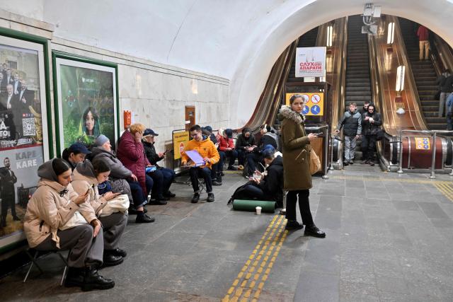 Local residents take shelter in an underground metro station  during an air strike alarm in Kyiv on March 18, 2026, amid the Russian invasion of Ukraine. (Photo by Sergei SUPINSKY / AFP)