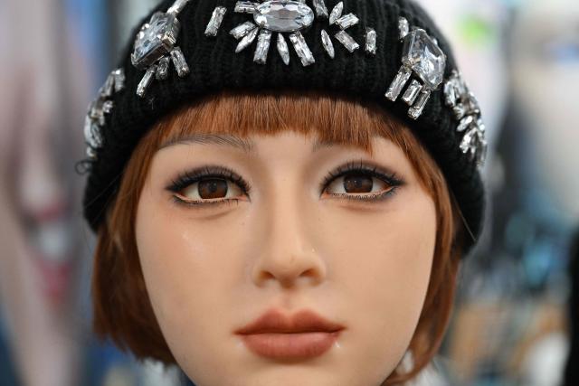 A humanoid robotic head that mimics human expressions from Shenzhen Xiaoquan Technology is displayed during the International AI Application and Robotics Innovation Exhibition in Beijing on March 18, 2026. (Photo by ADEK BERRY / AFP)