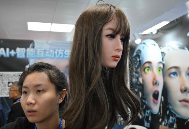 A humanoid robotic head that mimics human expressions from Shenzhen Xiaoquan Technology is displayed during the International AI Application and Robotics Innovation Exhibition in Beijing on March 18, 2026. (Photo by ADEK BERRY / AFP)