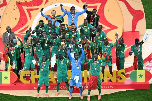 (FILES) Senegal players celebrate with the trophy after winning the Africa Cup of Nations (CAN) final football match against Morocco at the Prince Moulay Abdellah Stadium in Rabat on January 18, 2026. Senegal say they will appeal after they were sensationally stripped of the Africa Cup of Nations title on March 18, 2026 and the Confederation of African Football (CAF) instead declared Morocco champions, two months after their chaotic final. (Photo by Paul ELLIS / AFP)