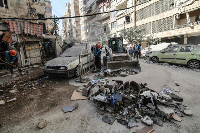 Municipality workers clear debris from a street after an Israeli airstrike in central Beirut's Zuqaq al-Blat neighbourhood on March 18, 2026. Lebanon was drawn into the Middle East war on March 2 when Iran-backed militant group Hezbollah launched rockets towards Israel in response to US-Israeli strikes that killed Iranian supreme leader Ayatollah Ali Khamenei. (Photo by Anwar AMRO / AFP)