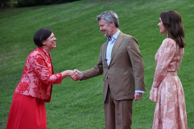 Denmark's King Frederik X (C) and Queen Mary (R) greet Ingrid Dahl-Madsen, the Danish Ambassador to Australia, during ‘An Evening in the Garden’ at the Royal Botanic Gardens in Melbourne on March 18, 2026. (Photo by Jesse Thompson / POOL / AFP)