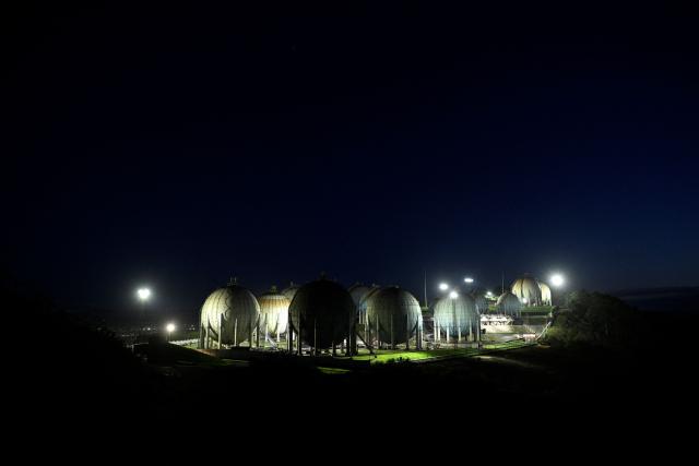 A picture taken at sunset on March 17, 2026 shows a general view of the Repsol LPG gas plant in the Spanish city of Gijon. The US-Israeli war on Iran has expanded across the Gulf and beyond, upending global energy markets and trade, and virtually halting traffic in the Strait of Hormuz, through which a fifth of the world's crude oil travels. (Photo by ANDER GILLENEA / AFP)