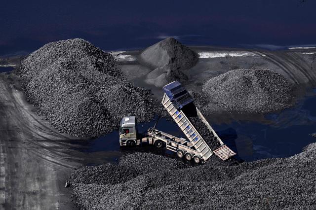 A picture taken on March 17, 2026 shows a truck loading coal at the Abono thermal power plant in the Spanish city of Gijon. The US-Israeli war on Iran has expanded across the Gulf and beyond, upending global energy markets and trade, and virtually halting traffic in the Strait of Hormuz, through which a fifth of the world's crude oil travels. (Photo by ANDER GILLENEA / AFP)