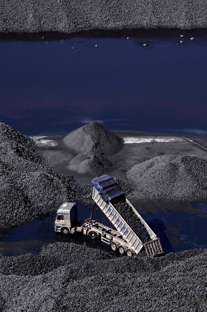 A picture taken on March 17, 2026 shows a truck loading coal at the Abono thermal power plant in the Spanish city of Gijon. The US-Israeli war on Iran has expanded across the Gulf and beyond, upending global energy markets and trade, and virtually halting traffic in the Strait of Hormuz, through which a fifth of the world's crude oil travels. (Photo by ANDER GILLENEA / AFP)