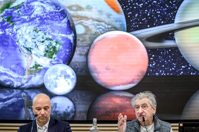 Swiss watchmaker Swatch Group CEO Nick Hayek gestures flanked by Tissot CEO Sylvain Dolla during a press conference to present the group's annual results in Biel on March 18, 2026. Swatch reported a plunge in net profit last year on weak demand for movements and other components, though it forecast a strong recovery in 2026. (Photo by Fabrice COFFRINI / AFP)