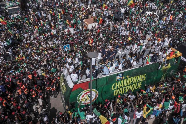(FILES) This aerial view shows Senegal's Football Team players as they ride on a bus past supporters during a trophy parade in the streets of Dakar on January 20, 2026 as they celebrate Senegal winning the Africa Cup of Nations (CAN) that was hosted in Morocco. Senegal football fans slammed AFCON'S decision to strip the country of its Africa Cup of Nations title and give it to Morocco, calling the move a "disgrace for Africa" as they woke up to the news Wednesday.
Gora Ndiaye, a resident of Dakar who works as a chauffeur, told AFP he felt like he had "been hit over the head" when he heard the news on the radio.
The Confederation of African Football (CAF) sensationally stripped Senegal of their title late Tuesday, citing regulations about leaving the field, which members did during the end of the final two months ago. (Photo by Mamadou Aliou Diallo / AFP)