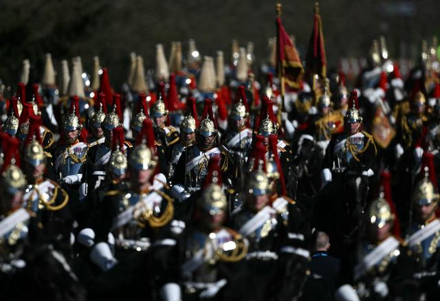 Members of the Blues and Royals, and Life Guards, units of the Household Cavalry, arrive on horseback in the grounds of Windsor Castle on March 18, 2026, on the first day of a two-day State Visit to the United Kingdom by Nigeria's President. (Photo by JUSTIN TALLIS / POOL / AFP)