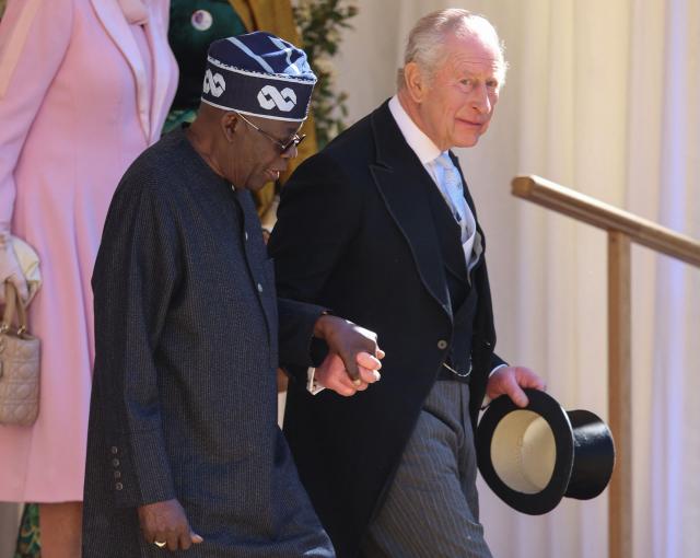 Britain's King Charles III and Nigeria's President Bola Tinubu holds hands as they leave following a ceremonial welcome in the Quadrangle at Windsor Castle, in Windsor, on March 18, 2026, on the first day of a two-day State Visit to the United Kingdom by Nigeria's President. (Photo by Chris Jackson / POOL / AFP)