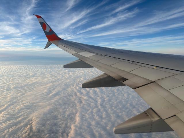 The wing of a GOL Airlines plane is seen amid the clouds after taking off from Guarulhos International Airport in Sao Paulo, Brazil, on March 18, 2026. (Photo by Pablo PORCIUNCULA / AFP)