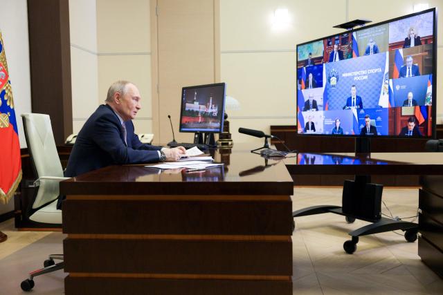 In this pool photograph distributed by the Russian state agency Sputnik, Russia's President Vladimir Putin chairs a meeting with members of the government via videoconference at the Novo-Ogaryovo residence outside Moscow on March 18, 2026. (Photo by Gavriil Grigorov / POOL / AFP)