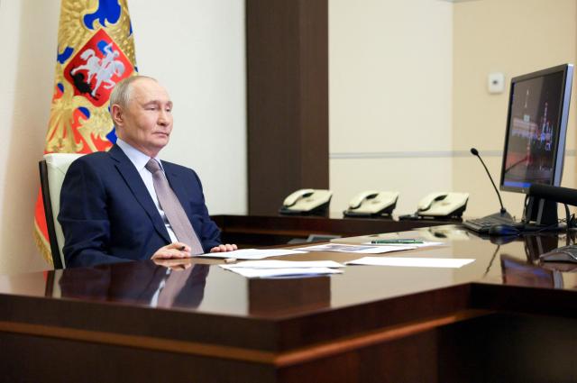 In this pool photograph distributed by the Russian state agency Sputnik, Russia's President Vladimir Putin chairs a meeting with members of the government via videoconference at the Novo-Ogaryovo residence outside Moscow on March 18, 2026. (Photo by Gavriil Grigorov / POOL / AFP)