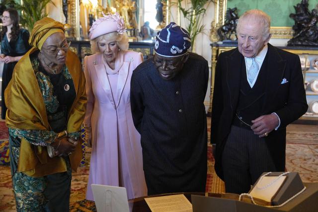 Britain's King Charles III (R), Nigeria's President Bola Tinubu (2R), Britain's Queen Camilla (L) and Nigeria's First Lady Oluremi Tinubu view a special exhibition of Royal Collection items, relating to Nigeria, in the Green Drawing Room at Windsor Castle , in Windsor, on March 18, 2026, on the first day of a two-day State Visit to the United Kingdom by Nigeria's President. (Photo by Aaron Chown / POOL / AFP)