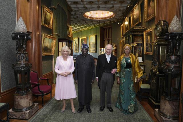 Britain's King Charles III and Nigeria's President Bola Tinubu stand with their wives Britain's Queen Camilla (L) and Nigeria's First Lady Oluremi Tinubu as they pose for a photograph in the Grand Corridor, during an audience at Windsor Castle, in Windsor, on March 18, 2026, on the first day of a two-day State Visit to the United Kingdom by Nigeria's President. (Photo by Aaron Chown / POOL / AFP)