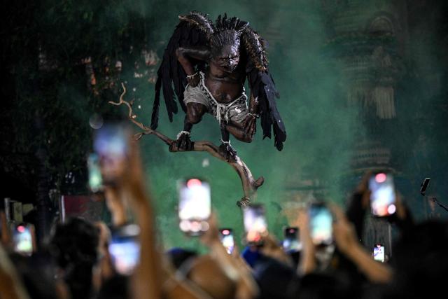 Hindu devotees carry effigies called 'ogoh-ogoh', symbolising an evil spirit, during a parade on the eve of Nyepi, the Day of Silence that marks the New Year in the Balinese Hindu calendar, in Denpasar, Bali on March 18, 2026. (Photo by Sonny TUMBELAKA / AFP)