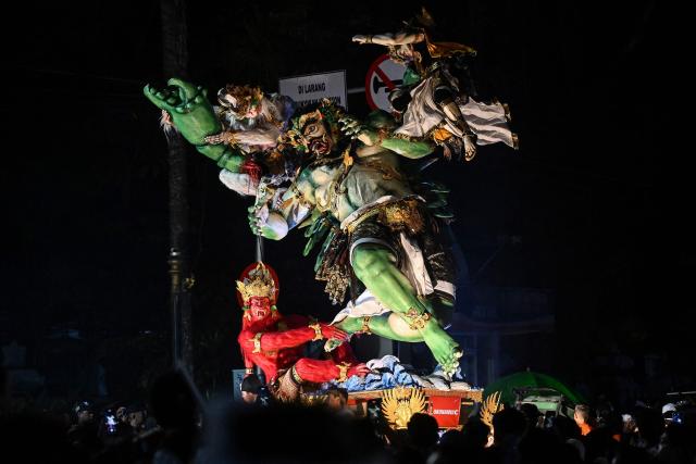 Hindu devotees carry effigies called 'ogoh-ogoh', symbolising an evil spirit, during a parade on the eve of Nyepi, the Day of Silence that marks the New Year in the Balinese Hindu calendar in Denpasar, Bali on March 18, 2026. (Photo by Sonny TUMBELAKA / AFP)