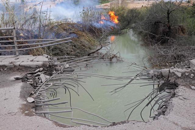 This photograph shows the destroyed Qasmiye Bridge built over the Litani River, following an Israeli airstrike, in Qasmiye on March 18, 2026. The Israeli military said it planned to strike bridges and crossings over the Litani River in southern Lebanon on March 18 to disrupt what it said were Hezbollah arms?smuggling routes. (Photo by KAWNAT HAJU / AFP)