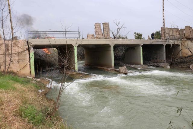 This photograph shows the destroyed Qasmiye Bridge built over the Litani River, following an Israeli airstrike, in Qasmiye on March 18, 2026. The Israeli military said it planned to strike bridges and crossings over the Litani River in southern Lebanon on March 18 to disrupt what it said were Hezbollah arms?smuggling routes. (Photo by KAWNAT HAJU / AFP)