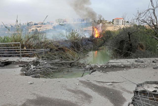TOPSHOT - This photograph shows the destroyed Qasmiye Bridge built over the Litani River, following an Israeli airstrike, in Qasmiye on March 18, 2026. The Israeli military said it planned to strike bridges and crossings over the Litani River in southern Lebanon on March 18 to disrupt what it said were Hezbollah arms?smuggling routes. (Photo by KAWNAT HAJU / AFP)