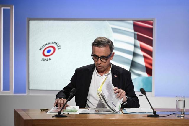 Bordeaux incumbent mayor Pierre Hurmic reviews his notes on the set of France 3 television in Bordeaux, south-western France, on March 18, 2026, ahead of a televised debate against Renaissance-Horizons challenger Thomas Cazenave before the second round of the 2026 French municipal elections on March 22. (Photo by Philippe LOPEZ / AFP)