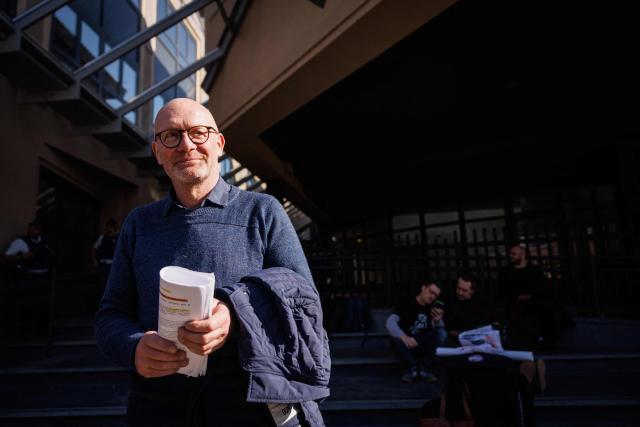 Belgian farmer Hugues Falys leaves the court, in which he seeks compensation from French oil giant TotalEnergies for damage to his farm caused by climate change, in Tournai, on March 18, 2026. Several groups and a Belgian farmer asked the court to order TotalEnergies to reduce its oil and gas production to "ease the existential anxiety" linked to climate change. (Photo by Simon Wohlfahrt / AFP)