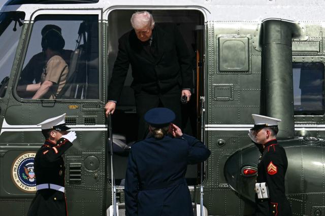 US President Donald Trump exits Marine One on his way to board Air Force One at Joint Base Andrews, Maryland, on his way to Dover Air Force Base in Delaware to attend a dignified transfer solemn event on March 18, 2026. President Trump is traveling to Dover Air Force Base to pay his respects to 6 US military members who were killed during a crash of a refueling aircraft in western Iraq last week. (Photo by Jim WATSON / AFP)