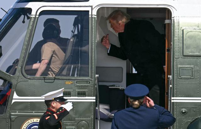 US President Donald Trump gives a thumbs up to Marine One pilots before boarding Air Force One at Joint Base Andrews, Maryland, on his way to Dover Air Force Base in Delaware to attend a dignified transfer solemn event on March 18, 2026. President Trump is traveling to Dover Air Force Base to pay his respects to 6 US military members who were killed during a crash of a refueling aircraft in western Iraq last week. (Photo by Jim WATSON / AFP)
