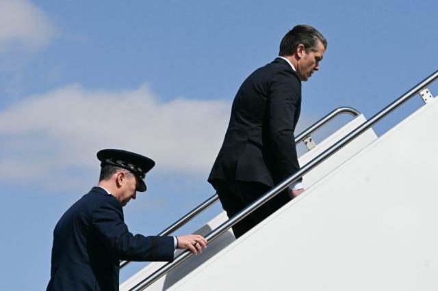 (L/R) Chairman of the Joint Chiefs of Staff General Dan Caine and US Secretary of Defense Pete Hegseth board Air Force One at Joint Base Andrews, Maryland, on their way to Dover Air Force Base in Delaware to attend a dignified transfer solemn event on March 18, 2026. President Donald Trump is traveling to Dover Air Force Base to pay his respects to 6 US military members who were killed during a crash of a refueling aircraft in western Iraq last week. (Photo by Jim WATSON / AFP)