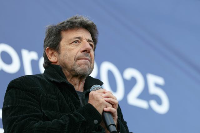 (FILES) French singer and actor Patrick Bruel looks on after speaking during a rally organised by the CRIF in support of Israeli hostages and in the memory of the victims of the October 7, 2023, in front of the Trocadero in Paris, on October 17, 2025. French singer and actor Patrick Bruel is the target of at least two complaints – one for sexual assault and attempted rape, and the other for rape – filed respectively in March 2026 week in Paris and in 2024 in Saint-Malo respectively, AFP learned from sources close to the case on March 18, 2026. (Photo by Alain JOCARD / AFP)