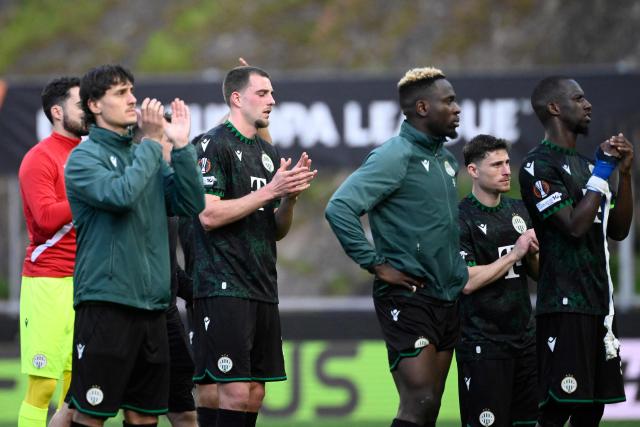 Ferencvaros players clap at the end of the UEFA Europa League last 16 second leg football match between SC Braga and Ferencvaros at Municipal stadium of Braga on March 18, 2026. (Photo by Miguel RIOPA / AFP)