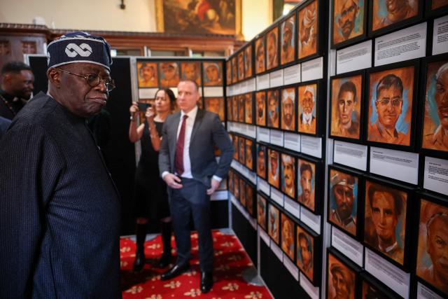 Nigeria's President Bola Ahmed Tinubu looks at art during a visit to Vicars' Hall in Windsor Castle, in Windsor, on March 18, 2026, on the first day of a two-day State Visit. (Photo by Isabel Infantes / POOL / AFP)