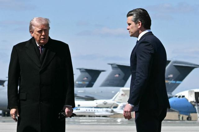 US President Donald Trump and Secretary of Defense Pete Hegseth step off Air Force One upon arrival at Dover Air Force Base to attend a dignified transfer solemn event in Dover, Delaware, on March 18, 2026. President Trump is attending a dignified transfer solemn event for 6 US military members who were killed during a crash of a refueling aircraft in western Iraq last week. (Photo by Jim WATSON / AFP)