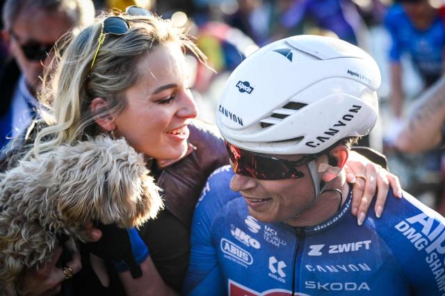 Belgian rider Jasper Philipsen celebrates with his partner Melanie Peetermans after winning the Nokere Koerse one-day cycling race in Kruisem on March 18, 2026. (Photo by ELIAS ROM / Belga / AFP) / Belgium OUT