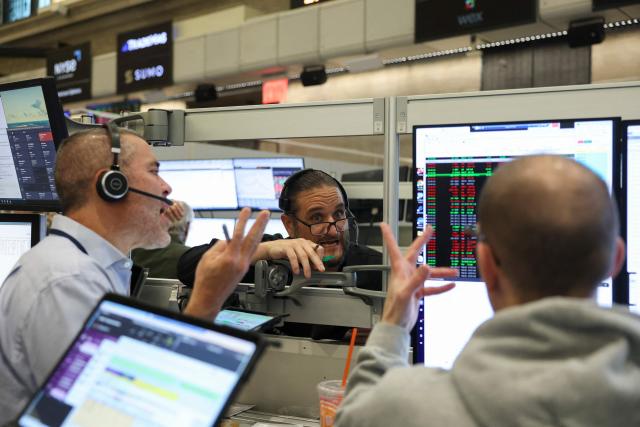 Traders work on the floor of the New York Stock Exchange (NYSE) in New York on March 18, 2026. The US Federal Reserve kept interest rates unchanged Wednesday as expected, in defiance of President Donald Trump as the world's largest economy battles stubborn inflation, weak labor demand and an "uncertain" economic outlook due to the war in Iran. The Fed's 11-1 vote kept rates steady at a range between 3.50 percent and 3.75 percent, with officials flagging one expected rate cut by the end of the year. (Photo by ANGELA WEISS / AFP)