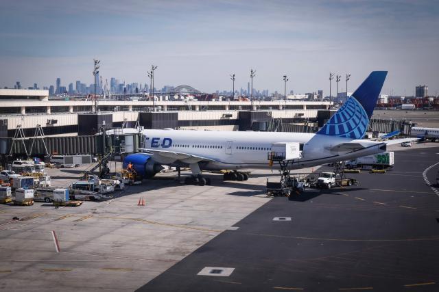 A United Airlines plane sits at a gate at Newark Liberty International Airport in Newark, New Jersey, on March 18, 2026. US airport security officers missed their first full paycheck on March 13 as a partial funding shutdown of the government approached the one-month mark, with no breakthrough in a congressional standoff that is beginning to disrupt travel across the country. The lapse in funding is forcing thousands of Transportation Security Administration (TSA) staff to work without pay as spring travel picks up, raising fears of staffing shortages, longer security lines and flight delays. (Photo by kena betancur / AFP)