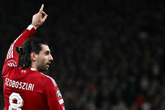 Liverpool's Hungarian midfielder #08 Dominik Szoboszlai celebrates scoring his team's first goal during the UEFA Champions League, round of 16 second leg football match between Liverpool and Galatasaray at Anfield in Liverpool, north-west England on March 18, 2026. (Photo by Paul ELLIS / AFP)