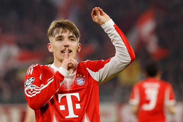 Bayern Munich's German midfielder #42 Lennart Karl celebrates scoring the 3-0 goal with his teammates during the UEFA Champions League, Round of 16 2nd-leg football match between FC Bayern Munich and Atalanta in Munich, southern Germany, on March 18, 2026. (Photo by Alexandra BEIER / AFP)