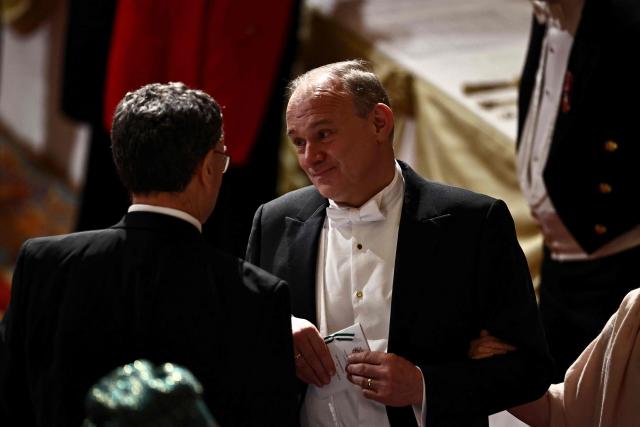 Liberal Democrat party leader Ed Davey speaks to Governor of the Bank of England, Andrew Bailey  during a State Banquet in St George's Hall, at Windsor Castle, in Windsor, on March 18, 2026, on the first day of a two-day State Visit to the United Kingdom by Nigeria's President. (Photo by Henry NICHOLLS / POOL / AFP)
