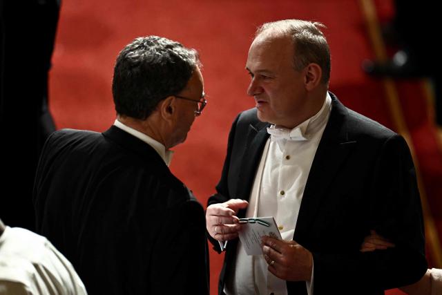 Liberal Democrat party leader Ed Davey speaks to Governor of the Bank of England, Andrew Bailey  during a State Banquet in St George's Hall, at Windsor Castle, in Windsor, on March 18, 2026, on the first day of a two-day State Visit to the United Kingdom by Nigeria's President. (Photo by Henry NICHOLLS / POOL / AFP)