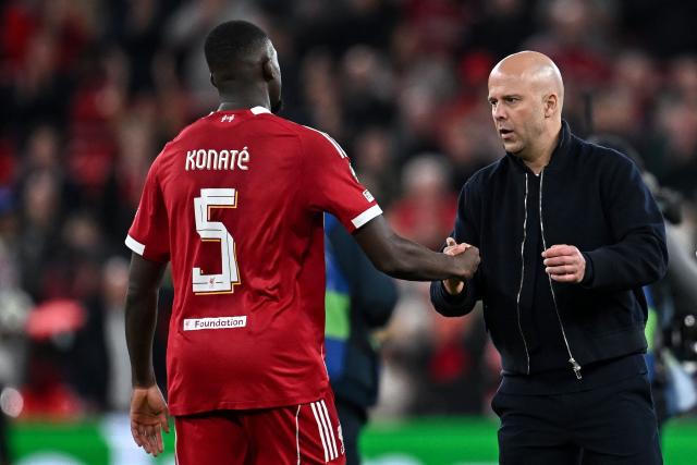 Liverpool's Dutch coach Arne Slot (R) greets Liverpool's French defender #05 Ibrahima Konate following the victory at the end of the UEFA Champions League, round of 16 second leg football match between Liverpool and Galatasaray at Anfield in Liverpool, north-west England on March 18, 2026. (Photo by Paul ELLIS / AFP)
