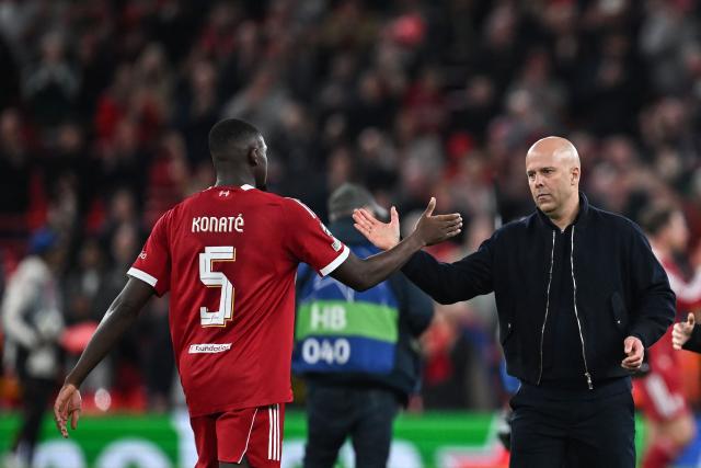 Liverpool's Dutch coach Arne Slot (R) greets Liverpool's French defender #05 Ibrahima Konate following the victory at the end of the UEFA Champions League, round of 16 second leg football match between Liverpool and Galatasaray at Anfield in Liverpool, north-west England on March 18, 2026. (Photo by Paul ELLIS / AFP)