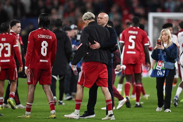 Liverpool's Dutch coach Arne Slot (C-R) greets Liverpool's French forward #22 Hugo Ekitike following the victory at the end of the UEFA Champions League, round of 16 second leg football match between Liverpool and Galatasaray at Anfield in Liverpool, north-west England on March 18, 2026. (Photo by Paul ELLIS / AFP)